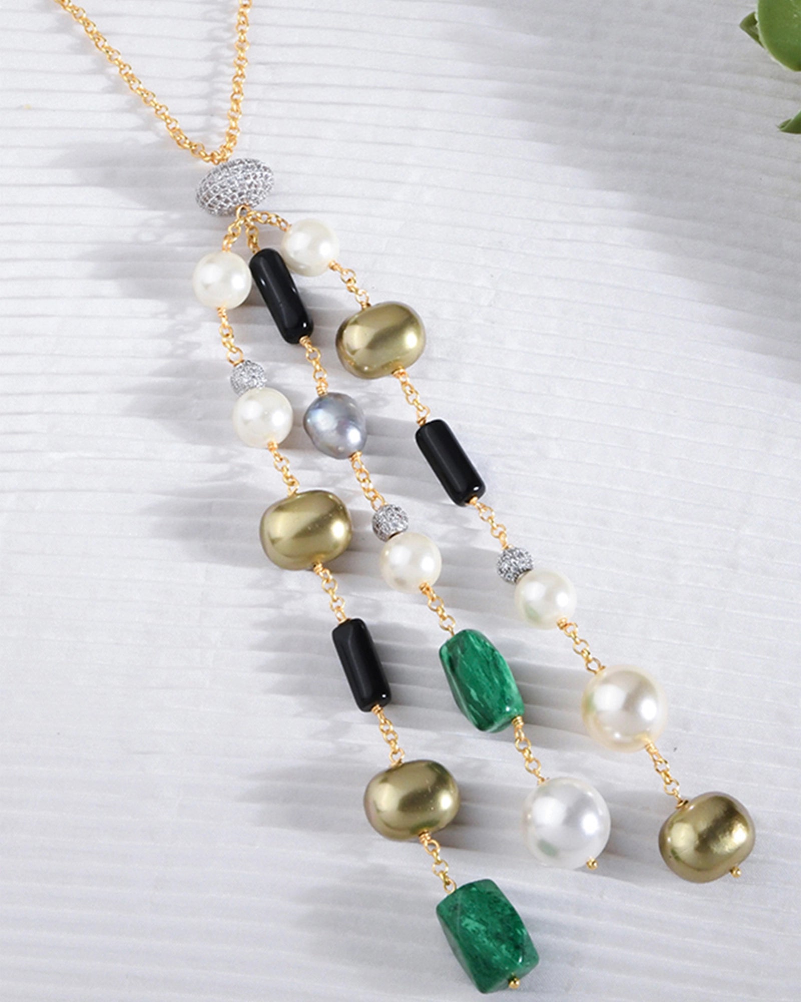 golden chain necklace with white, golden, and black pearls