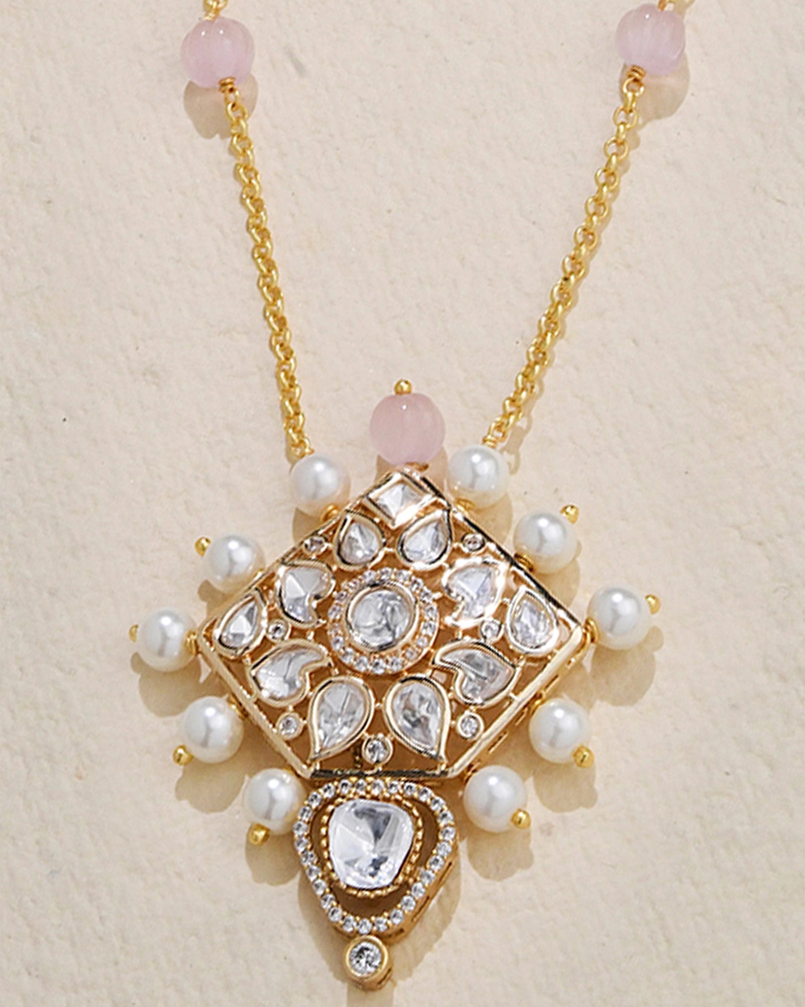 delicate chain adorned with a petite Polki pendant and a few elegant pearls