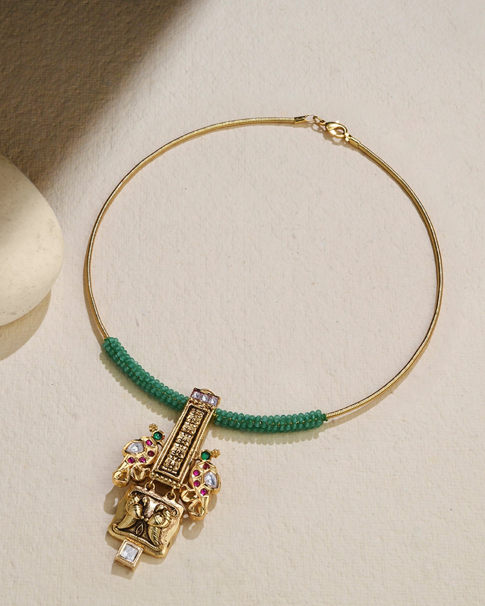  golden wired necklace wrapped with vibrant green beads 