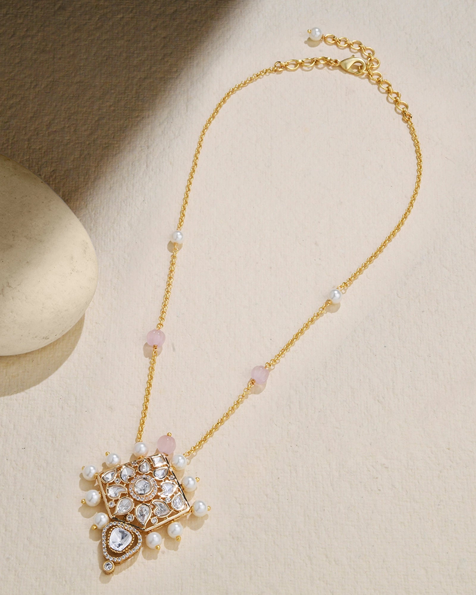 delicate chain adorned with a petite Polki pendant and a few elegant pearls