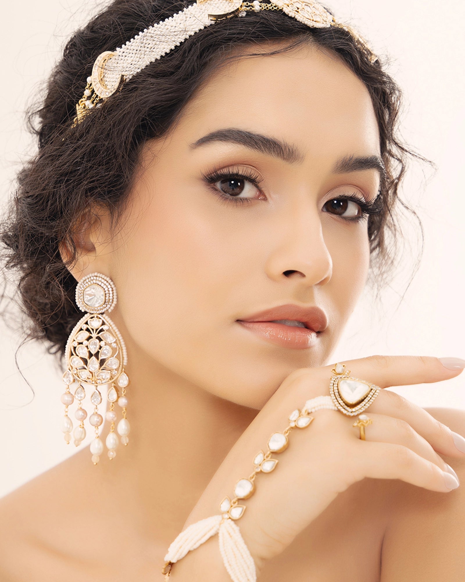 Radiant gold earrings adorned with polki pearls and a yellow gold finish.